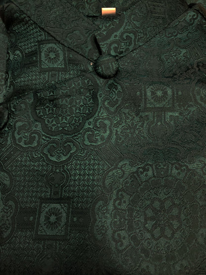 Dark green patterned fabric with a close-up view
