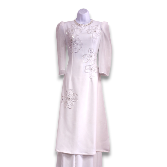 White embroidered ao dai dress on a mannequin against a white background